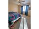 Bright bedroom with a queen bed, window, and ceiling fan at 17572 W Dalea Dr, Goodyear, AZ 85338
