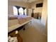 Comfortable bedroom with a queen bed, dresser, and ceiling fan at 17572 W Dalea Dr, Goodyear, AZ 85338