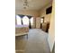 Spacious bedroom with a queen bed, dresser, and large window at 17572 W Dalea Dr, Goodyear, AZ 85338