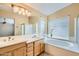 Double sink vanity plus soaking tub and window make this bathroom bright and luxurious at 4803 E Barwick Dr, Cave Creek, AZ 85331