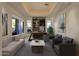 Bright home office with built-in shelving and comfortable seating at 10751 E Candlewood Dr, Scottsdale, AZ 85255