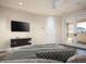 Bedroom featuring a modern media center, ensuite balcony, and neutral color palette at 6296 N Lost Dutchman Dr, Paradise Valley, AZ 85253