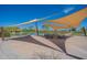 Shaded picnic area with tables and overhead canopies, offering a relaxing outdoor dining space near the lake at 5809 W Victory Ct, Florence, AZ 85132