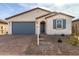 One story home with gray garage door and small front yard at 40449 W Wade Dr, Maricopa, AZ 85138