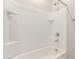 Clean bathroom with a shower/tub combo and white tile surround at 40347 W Wade Dr, Maricopa, AZ 85138