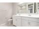 Bright bathroom boasts double sinks, white cabinets, and a shower/tub combo at 40347 W Wade Dr, Maricopa, AZ 85138