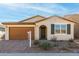 One-story home with brown garage door, green shutters, and landscaped yard at 40347 W Wade Dr, Maricopa, AZ 85138