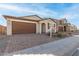Home's exterior with a brick driveway at 40347 W Wade Dr, Maricopa, AZ 85138