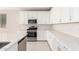 Modern kitchen with white cabinets, stainless steel appliances, and white countertops at 40347 W Wade Dr, Maricopa, AZ 85138