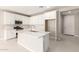 White kitchen with island, stainless steel appliances, and white cabinets at 40347 W Wade Dr, Maricopa, AZ 85138