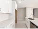 Modern kitchen with white cabinets, island, and stainless steel appliances at 40347 W Wade Dr, Maricopa, AZ 85138
