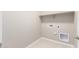 Bright laundry room with built-in shelving at 40347 W Wade Dr, Maricopa, AZ 85138