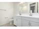 Elegant bathroom featuring double sinks, white cabinetry, and chrome fixtures, creating a serene space at 18812 E Elizar Dr, Gold Canyon, AZ 85118