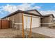 Front exterior featuring a two-car garage, neutral stucco, and low-maintenance landscaping at 18812 E Elizar Dr, Gold Canyon, AZ 85118