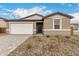 Charming single-story home featuring a two car garage, neutral color palette, and low maintenance landscaping at 18812 E Elizar Dr, Gold Canyon, AZ 85118
