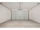 Spacious two-car garage featuring a clean concrete floor and an insulated door at 18812 E Elizar Dr, Gold Canyon, AZ 85118