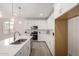 White kitchen features a large island with seating, stainless steel appliances, and lots of counter space at 18812 E Elizar Dr, Gold Canyon, AZ 85118