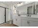Modern bathroom with double vanity and a walk-in shower at 40461 W Wade Dr, Maricopa, AZ 85138