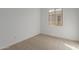 Spacious bedroom with carpeted floor and large window at 40461 W Wade Dr, Maricopa, AZ 85138
