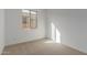 Well-lit bedroom, featuring carpeted floors and a window at 40461 W Wade Dr, Maricopa, AZ 85138