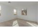 Simple bedroom with neutral carpeting and large windows at 40461 W Wade Dr, Maricopa, AZ 85138