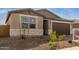 Modern one-story home with brown garage door at 40461 W Wade Dr, Maricopa, AZ 85138