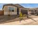 Modern one-story home with brown garage door at 40461 W Wade Dr, Maricopa, AZ 85138