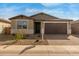 Modern one-story home with brown garage door at 40461 W Wade Dr, Maricopa, AZ 85138