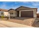 Modern one-story home with brown garage door at 40461 W Wade Dr, Maricopa, AZ 85138