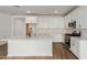 Modern kitchen featuring white cabinets and a large island at 40461 W Wade Dr, Maricopa, AZ 85138
