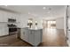 Open concept kitchen and living area with modern finishes at 40461 W Wade Dr, Maricopa, AZ 85138