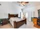 Second bedroom with a wooden bed frame and built-in workspace at 6145 E Sierra Morena St, Mesa, AZ 85215