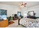 Main bedroom with a large bed, a workspace, and high ceilings at 6145 E Sierra Morena St, Mesa, AZ 85215
