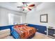 Bedroom with a full-size bed and blue accent wall at 6145 E Sierra Morena St, Mesa, AZ 85215