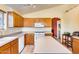 Kitchen boasts light wood cabinets, an island, and white appliances at 6145 E Sierra Morena St, Mesa, AZ 85215