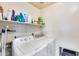 Laundry room with washer, dryer, and shelving for storage at 6145 E Sierra Morena St, Mesa, AZ 85215