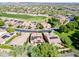 Aerial view of neighborhood featuring homes with solar panels and a golf course at 29110 N 129Th Ave, Peoria, AZ 85383