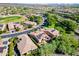 Aerial view of neighborhood with golf course and numerous homes with solar panels at 29110 N 129Th Ave, Peoria, AZ 85383
