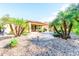 Landscaped backyard with patio and palm trees at 29110 N 129Th Ave, Peoria, AZ 85383