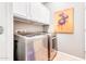 Laundry room with washer, dryer, and overhead cabinets at 29110 N 129Th Ave, Peoria, AZ 85383