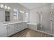 Elegant bathroom with dual vanity, soaking tub, and glass-enclosed shower at 12312 W Luxton Ln, Avondale, AZ 85323