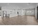 Spacious open-concept kitchen with stainless steel appliances, island, and wood floors at 12312 W Luxton Ln, Avondale, AZ 85323