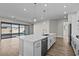 Open-concept kitchen with an island, stainless steel appliances, and a view of the living area at 12312 W Luxton Ln, Avondale, AZ 85323