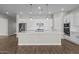 Modern kitchen with a large island, stainless steel appliances, and white cabinetry at 12312 W Luxton Ln, Avondale, AZ 85323