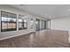 Bright and airy living room with wood-style flooring, large windows, and a view of the backyard at 12312 W Luxton Ln, Avondale, AZ 85323