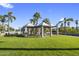 Outdoor gazebo on a green lawn with nearby palm trees provides a relaxing community gathering space at 1040 E Osborn Rd # 302, Phoenix, AZ 85014