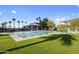 Community pool with a covered seating area and lush landscaping on a sunny day at 1040 E Osborn Rd # 302, Phoenix, AZ 85014