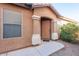 Front entry with brown door and sidelights at 21129 N Grantham Rd, Maricopa, AZ 85138