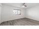 Bright bedroom with wood-look floors and ceiling fan at 9911 W Pleasant Valley Rd, Sun City, AZ 85351