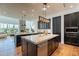 Open kitchen with stainless steel appliances, wood floors, and granite countertops at 3965 E Sierra Vista Dr, Paradise Valley, AZ 85253
